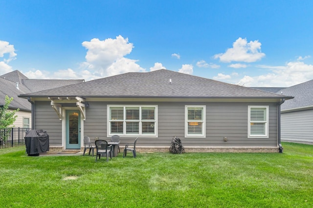 rear view of house featuring a yard