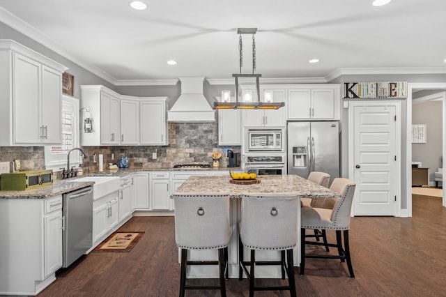 kitchen with decorative light fixtures, a kitchen island, dark hardwood / wood-style flooring, custom range hood, and stainless steel appliances