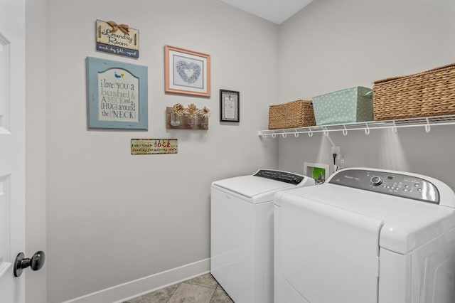 laundry room with washing machine and dryer and light tile patterned floors