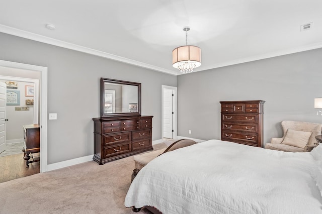 bedroom with crown molding, light carpet, and an inviting chandelier