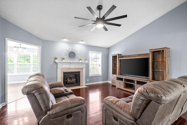 living room featuring a fireplace, ceiling fan, vaulted ceiling, and hardwood / wood-style floors