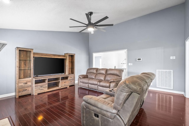 living room with lofted ceiling, ceiling fan, and dark hardwood / wood-style flooring