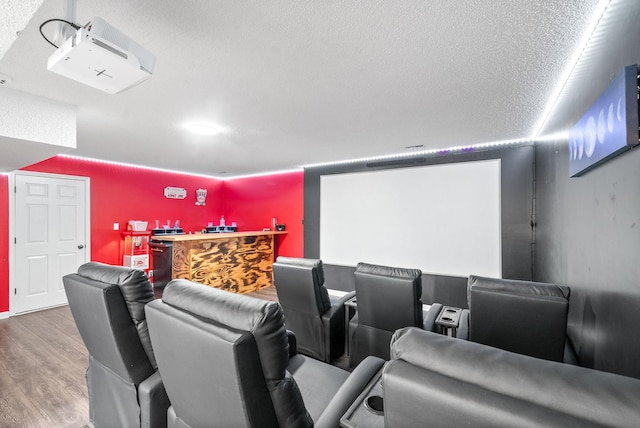 cinema featuring a textured ceiling and hardwood / wood-style floors