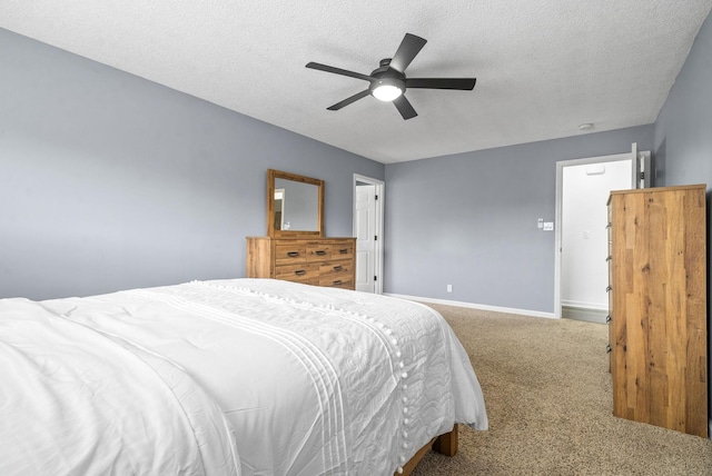 bedroom with ceiling fan, carpet floors, and a textured ceiling