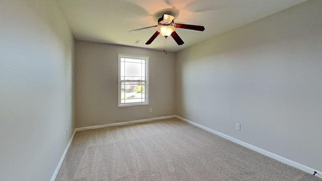 spare room with light colored carpet and ceiling fan