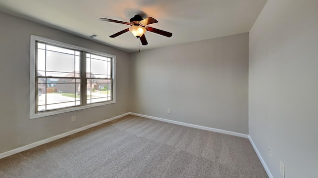 spare room with carpet floors and ceiling fan