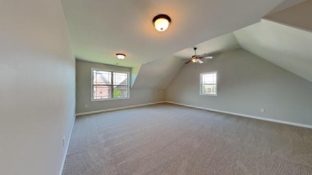 bonus room featuring carpet, a wealth of natural light, and lofted ceiling