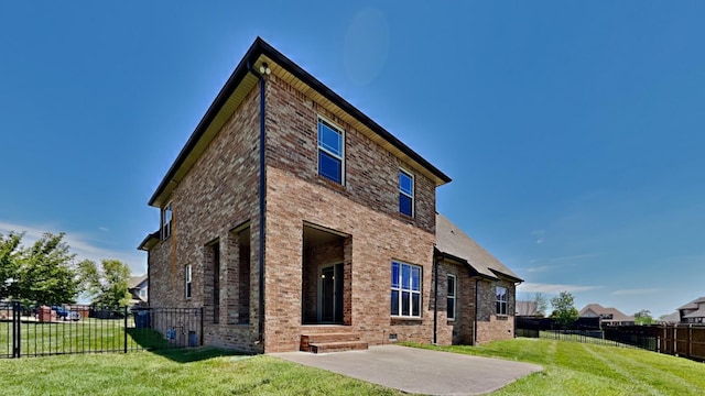 rear view of property with a yard and a patio area