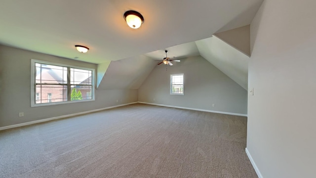 bonus room featuring carpet flooring and vaulted ceiling