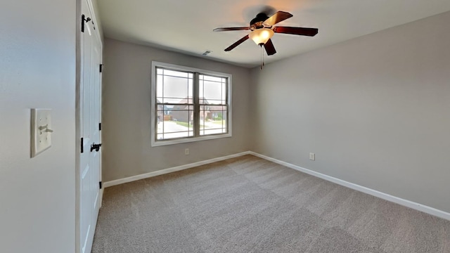 empty room with light carpet and ceiling fan