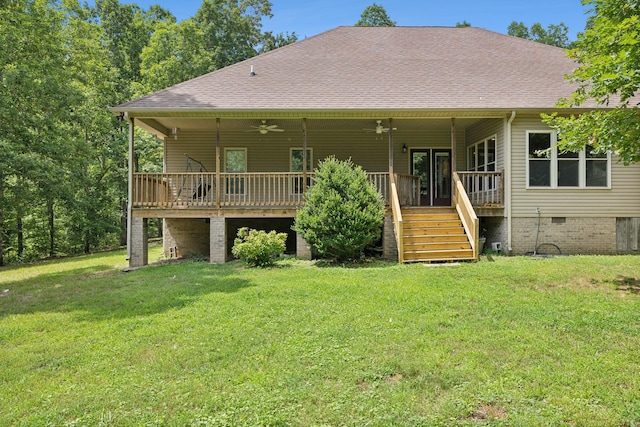 back of property featuring a lawn, ceiling fan, and a deck