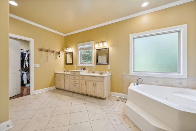 bathroom with tile patterned floors, a bathtub, vanity, and ornamental molding