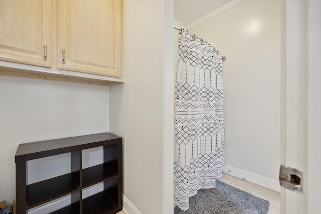 bathroom with tile patterned flooring and crown molding