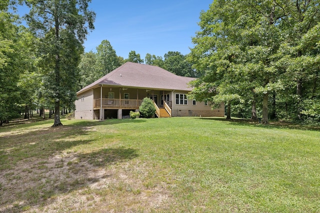 rear view of house with covered porch and a yard