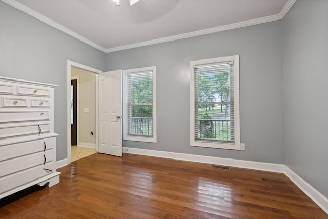 unfurnished bedroom with hardwood / wood-style flooring, ceiling fan, and ornamental molding