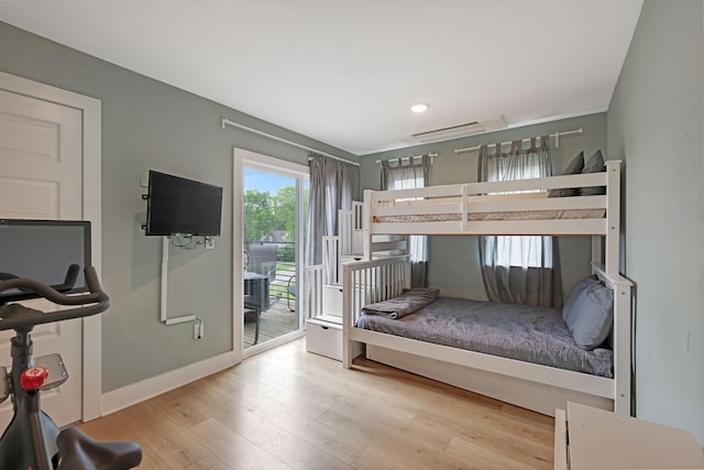 unfurnished bedroom with access to exterior, visible vents, baseboards, and light wood-style floors