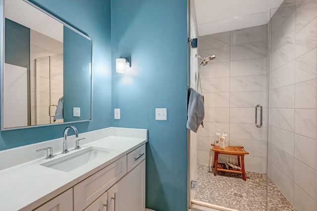 bathroom featuring vanity and a shower with door