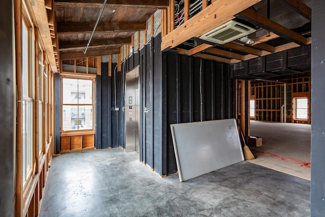 miscellaneous room with a wealth of natural light and concrete flooring