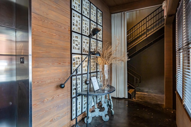 room details featuring elevator and wooden walls