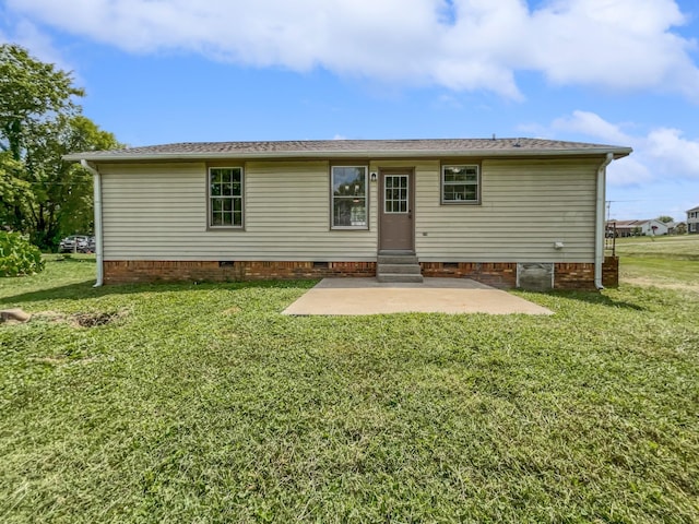 back of house with a patio and a lawn