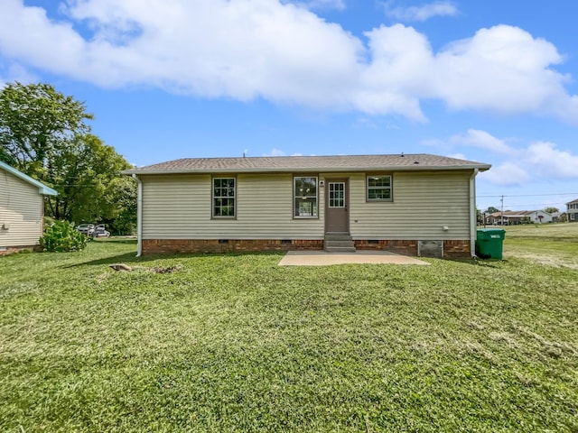 rear view of house featuring a yard and a patio