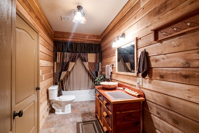 full bathroom featuring shower / bath combination with curtain, vanity, toilet, and wooden walls