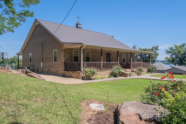 back of property featuring a lawn and covered porch