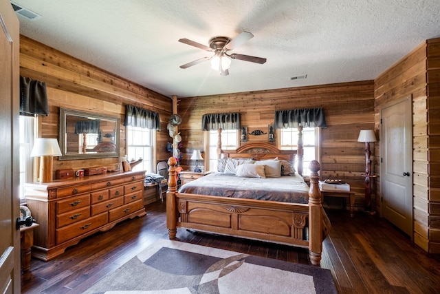 351 New Era Landing Rd, Linden, TN 37096 - bedroom featuring wood walls, multiple windows, dark wood finished floors, a textured ceiling, and ceiling fan