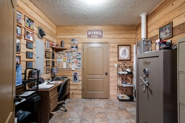 home office featuring a textured ceiling and wooden walls