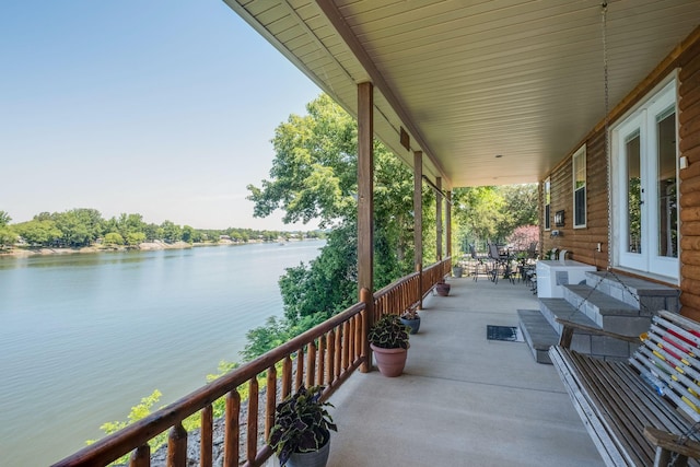 view of patio featuring a water view and a porch