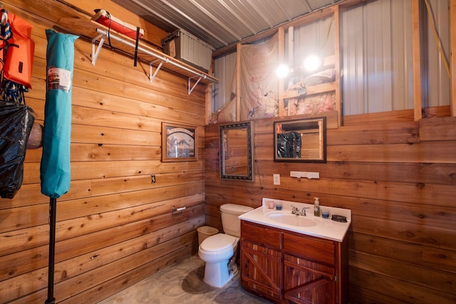 bathroom with vanity, toilet, wooden ceiling, and wooden walls