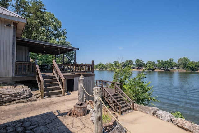 view of patio with a deck with water view