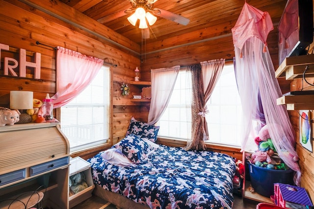 bedroom featuring ceiling fan, wood walls, wood ceiling, and multiple windows