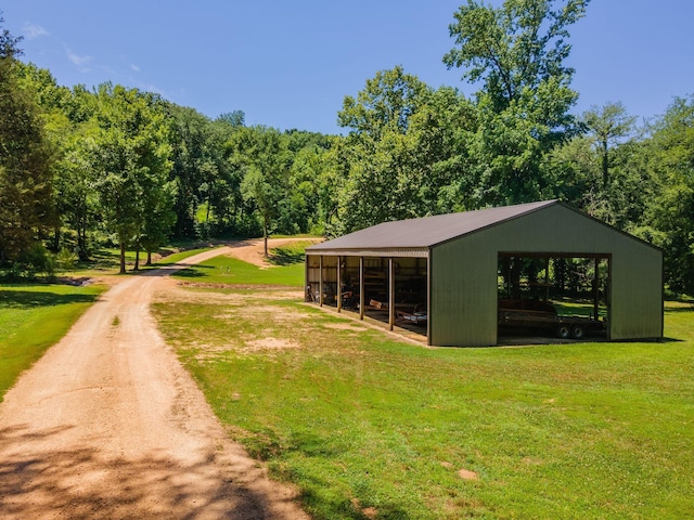 view of home's community with an outbuilding and a yard