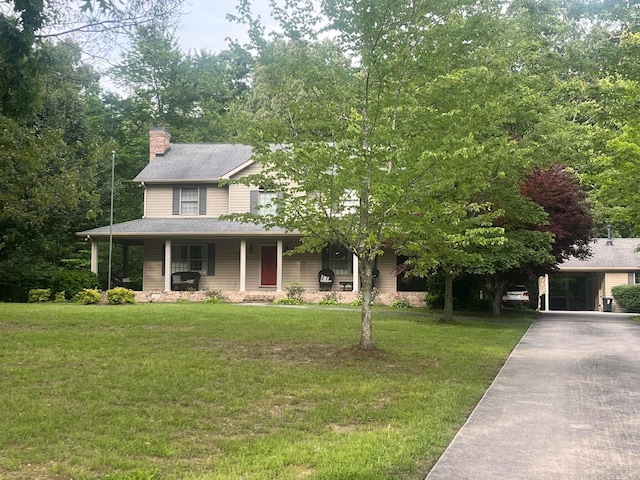 view of front of house featuring a front lawn and covered porch