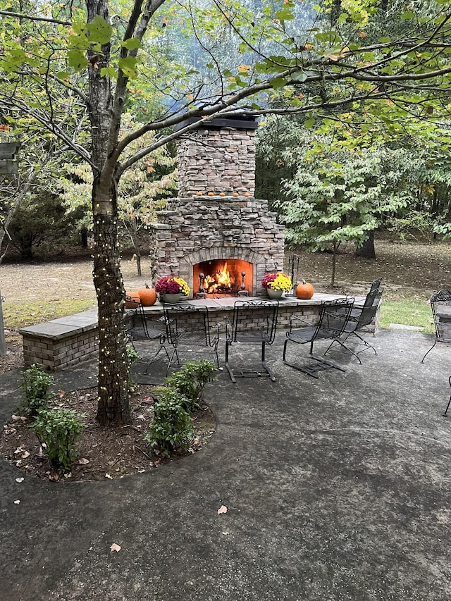 view of patio featuring an outdoor stone fireplace