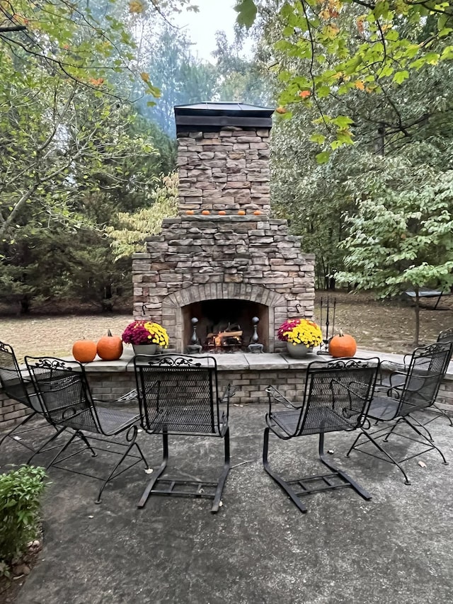 view of patio / terrace featuring an outdoor stone fireplace