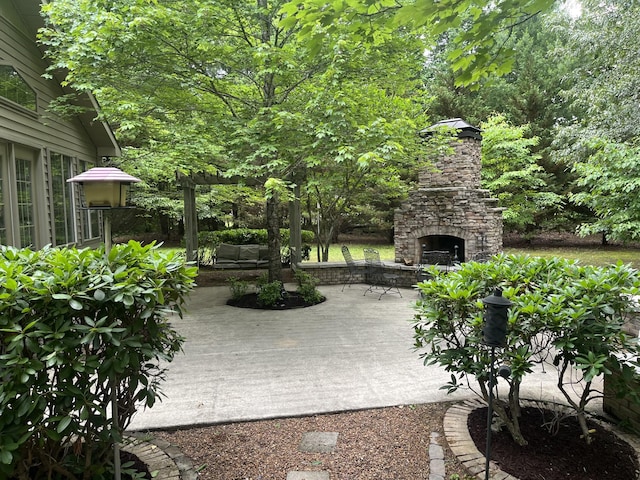 view of patio featuring an outdoor stone fireplace