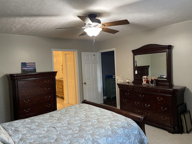 carpeted bedroom featuring ceiling fan, connected bathroom, and a textured ceiling