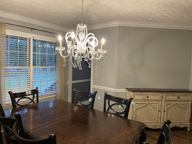 dining area with wood-type flooring, ornamental molding, a chandelier, and a textured ceiling