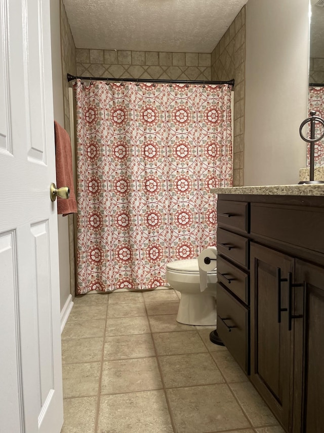 bathroom featuring vanity, toilet, and a textured ceiling