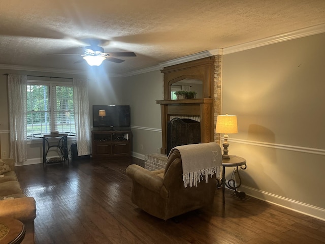 living area with a fireplace, ornamental molding, and dark hardwood / wood-style floors