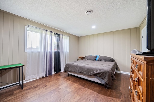 bedroom featuring hardwood / wood-style flooring and a textured ceiling