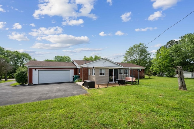 ranch-style home with a garage and a front yard