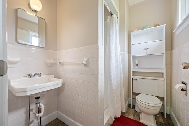 bathroom with tile walls, backsplash, a wealth of natural light, toilet, and hardwood / wood-style flooring