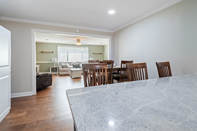 dining room with crown molding, ceiling fan, and dark hardwood / wood-style flooring