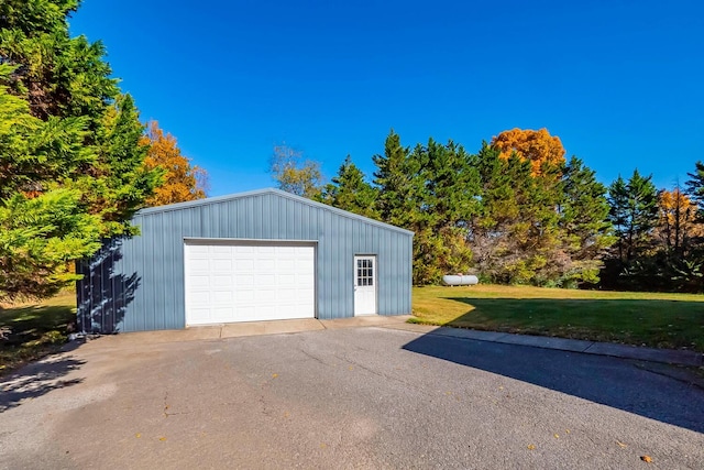 garage featuring a lawn