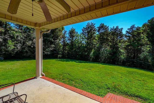 view of yard with ceiling fan and a patio