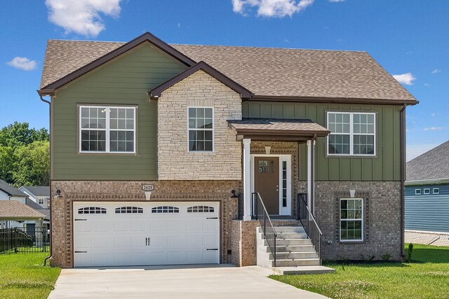 bi-level home with a garage and a front lawn