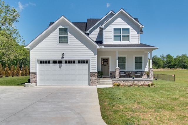 craftsman inspired home with a garage, a front yard, and a porch